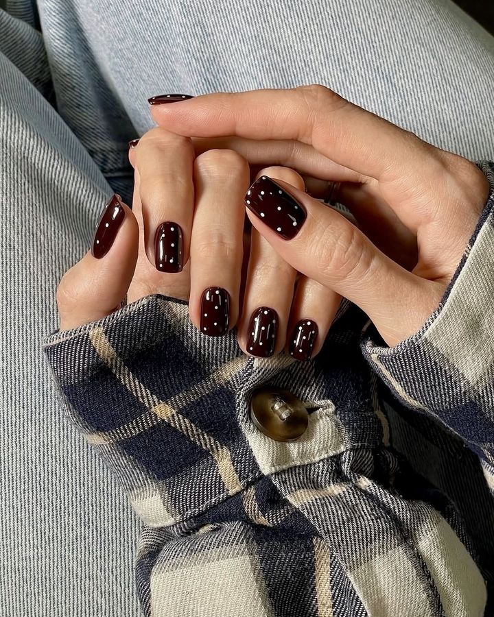 Short nails in very dark red-brown with small white dots