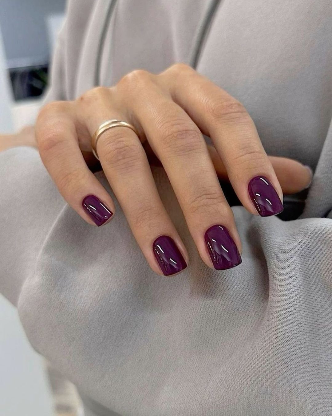 Short square nails in glossy dark plum purple